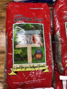 Photo of Elite Wild Bird Seed. Bag of seed is red with birdhouse and cardinal image superimposed on bag material.