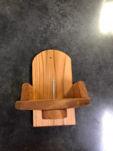 Photo of wooden 'squirrel chair' with rounded back and screw through the center to attach corn to.