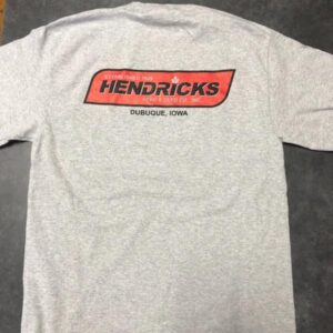 Photo of gray Hendricks Feed T-shirt with red Hendricks logo in corner and black outline.